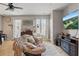 Bright living room with a cozy chair, dresser, and modern entertainment setup at 5489 Baldwin Park St, Orlando, FL 32814