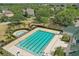 Overhead shot of the swimming pool with lanes, a pool, and community buildings surrounded by lush landscaping at 5489 Baldwin Park St, Orlando, FL 32814