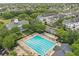Aerial view showcasing a community pool area, with abundant lounge seating, a separate ' pool, and manicured landscaping at 5489 Baldwin Park St, Orlando, FL 32814