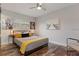 Comfortable bedroom with a queen bed, modern ceiling fan, and beautiful artwork at 550 Birch Ct, Altamonte Springs, FL 32714