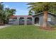 Charming home with a well-manicured lawn and a mature palm tree in the front yard at 550 Birch Ct, Altamonte Springs, FL 32714