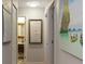 Hallway with beach-themed art and a peek into the modern bathroom at 550 Birch Ct, Altamonte Springs, FL 32714