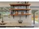 Farmhouse shelves with decor sit above the kitchen sink and granite counters at 550 Birch Ct, Altamonte Springs, FL 32714