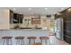 Modern kitchen with stainless steel appliances, granite countertops, and seating for five at 550 Birch Ct, Altamonte Springs, FL 32714