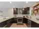 A modern kitchen features dark wood cabinets and stainless appliances at 550 Birch Ct, Altamonte Springs, FL 32714