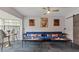 Comfortable lounge area with stylish blue seating, artwork, and a sliding barn door at 550 Birch Ct, Altamonte Springs, FL 32714