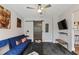 Comfortable seating area with a blue sofa, mounted TV, and a sliding barn door at 550 Birch Ct, Altamonte Springs, FL 32714