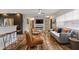 Open-concept living area featuring wood flooring, comfortable seating, and a kitchen bar at 550 Birch Ct, Altamonte Springs, FL 32714