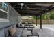 Covered patio with a large sectional sofa and stylish coffee tables for outdoor lounging at 550 Birch Ct, Altamonte Springs, FL 32714