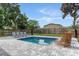 Backyard pool with modern lounge chairs, wicker seating, and a lush green lawn at 550 Birch Ct, Altamonte Springs, FL 32714