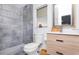 Modern bathroom features gray tiling, a wood vanity, and an updated toilet at 631 Trailwood Dr, Altamonte Springs, FL 32714