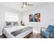Bright bedroom features a ceiling fan, large window, and neutral paint at 631 Trailwood Dr, Altamonte Springs, FL 32714