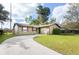 Charming single-story home with a well-maintained front yard and a long, curved driveway at 631 Trailwood Dr, Altamonte Springs, FL 32714