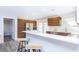 Bright kitchen with stainless steel appliances, wooden cabinets, and a breakfast bar seating area at 631 Trailwood Dr, Altamonte Springs, FL 32714