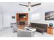 Bright living room features a brick fireplace, ceiling fan, neutral paint, and a stylish seating arrangement at 631 Trailwood Dr, Altamonte Springs, FL 32714