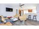 Open-concept living area with modern furniture, sleek kitchen, and inviting breakfast bar seating at 631 Trailwood Dr, Altamonte Springs, FL 32714