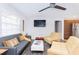 Bright living room featuring a comfortable couch, contemporary furniture, and a ceiling fan at 631 Trailwood Dr, Altamonte Springs, FL 32714