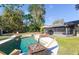 Backyard boasts a pool, lounge chairs, a sun umbrella, screened-in patio, and a fire pit at 631 Trailwood Dr, Altamonte Springs, FL 32714