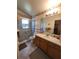 Bathroom featuring a marble shower, laminate countertops and a large mirror at 6434 Tidewave St, Orlando, FL 32822