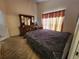 Spacious bedroom featuring neutral carpet, a large window and dresser with mirror at 6434 Tidewave St, Orlando, FL 32822