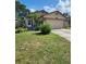 Charming single-Gathering home with a well-manicured lawn and inviting curb appeal at 6434 Tidewave St, Orlando, FL 32822