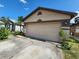A two-car garage with ample parking space and a neatly paved driveway at 6434 Tidewave St, Orlando, FL 32822