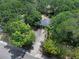 An aerial view highlights the property's driveway and lush surroundings at 670 N Sparkman Ave, Orange City, FL 32763