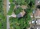 An aerial view showcases a secluded property surrounded by lush, mature trees at 670 N Sparkman Ave, Orange City, FL 32763