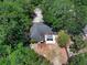 An aerial view reveals a private property with a covered patio and mature landscaping at 670 N Sparkman Ave, Orange City, FL 32763