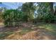 Large backyard with lush, mature landscaping and a full wooden fence surrounding the property at 670 N Sparkman Ave, Orange City, FL 32763