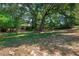 Expansive backyard featuring mature trees offering ample shade and natural beauty at 670 N Sparkman Ave, Orange City, FL 32763