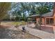Backyard featuring landscaping, large trees, outdoor dining area, and covered gazebo at 670 N Sparkman Ave, Orange City, FL 32763