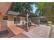 Backyard view of covered gazebo and outdoor dining area on a brick and painted patio at 670 N Sparkman Ave, Orange City, FL 32763