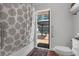 Bathroom featuring a walk in shower and outdoor access to a back patio area at 670 N Sparkman Ave, Orange City, FL 32763