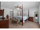 Bedroom featuring a four-poster bed, ceiling fan, and carpet flooring at 670 N Sparkman Ave, Orange City, FL 32763