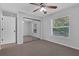 Bedroom featuring a ceiling fan, mirrored closet and carpet flooring at 670 N Sparkman Ave, Orange City, FL 32763