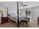 Bedroom featuring a four-poster bed, ceiling fan, and natural light at 670 N Sparkman Ave, Orange City, FL 32763