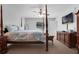 Bedroom featuring a four-poster bed, ceiling fan, and wood dresser at 670 N Sparkman Ave, Orange City, FL 32763