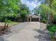 Single-story home with lush landscaping, long driveway, and an attached two-car garage at 670 N Sparkman Ave, Orange City, FL 32763