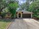 Charming single-story home featuring a well-manicured front yard and attached two-car garage at 670 N Sparkman Ave, Orange City, FL 32763