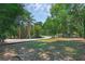 Expansive front yard with mature trees and lush greenery, creating a serene setting at 670 N Sparkman Ave, Orange City, FL 32763