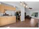 Open kitchen with tile floors, light wood cabinets, and black appliances at 670 N Sparkman Ave, Orange City, FL 32763