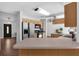 Open kitchen with stainless steel appliances and light wood cabinets at 670 N Sparkman Ave, Orange City, FL 32763