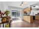 Bright kitchen with tile floors and light wood cabinets with access to back patio at 670 N Sparkman Ave, Orange City, FL 32763