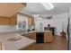 Kitchen featuring wooden cabinets, updated appliances, and large sink with window view at 670 N Sparkman Ave, Orange City, FL 32763