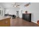 Open-concept office space with adjacent kitchen area and a wooden cabinet at 670 N Sparkman Ave, Orange City, FL 32763