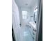 Bathroom featuring neutral tile flooring, white cabinets, black fixtures, and natural light at 7147 Yacht Basin Ave # 119, Orlando, FL 32835