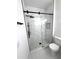 Modern bathroom with glass enclosed shower and marble tile at 7147 Yacht Basin Ave # 119, Orlando, FL 32835