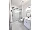 Bathroom featuring a glass shower, updated sink and fixtures and white tiling at 7147 Yacht Basin Ave # 119, Orlando, FL 32835