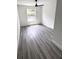 Bright bedroom with modern ceiling fan, a window, and beautiful grey wood flooring at 7147 Yacht Basin Ave # 119, Orlando, FL 32835